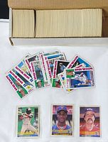 overview of storage box filled with cards, loose stack of Expos cards and three sleeved cards