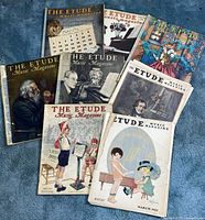 All eight Etude magazines fanned out showing various illustrated covers