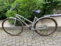 Left side view of entire Peugeot bicycle showing frame, wheels and components