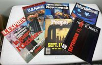 All six magazines arranged on table showing covers