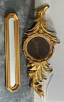 Round foliate mirror and elongated octagonal mirror displayed side by side