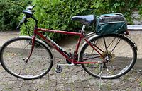 Full side view of red Specialized Crossroads bicycle with attached trunk bag