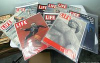 Group shot of all ten Life magazines in plastic sleeves