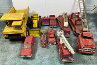 All 10 vehicles arranged, showing relative sizes and mix of construction and fire trucks
