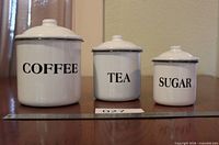 Front view of all three labeled canisters with lids