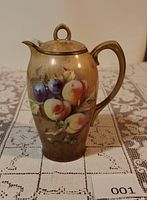 Front view showing fruit motif, handle and lid