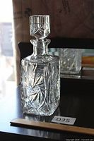 Front view of crystal square decanter with stopper