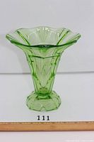 Front view of uranium green pressed glass vase