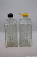 Front view of both glass decanters with lids attached