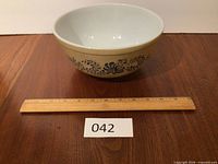 Full view of Pyrex Homestead bowl beside 12-inch ruler