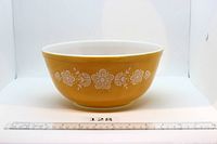 Side view of yellow Pyrex bowl showing full Butterfly Gold pattern