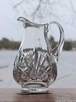 Full view of clear crystal pitcher showing overall form and handle