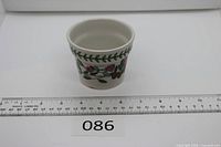 Front view showing floral decoration and scale ruler