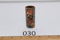 Front view of brass cloisonné lighter cover with ruler for scale