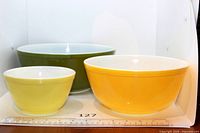 Front view of three nesting Pyrex bowls showing colours and sizes