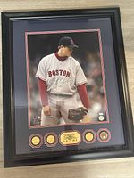 Full view of framed autographed photo with coins and certificate