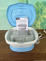 Paraffin bath open showing interior, wax packs, manual and power cord