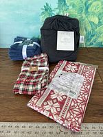 All four packaged textile items displayed with measuring ruler for scale