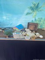 Overall view of craft lot with wood cut-outs, felt, dowels, boxes, hoop and slice on table