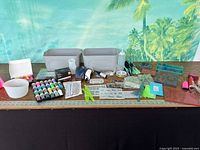 Overall lot on table with bins, molds, paints, tools