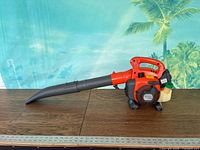 Full view of Husqvarna 125B leaf blower with nozzle attached on tabletop