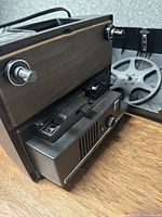 Projector open showing reel arm, gate and interior mechanism