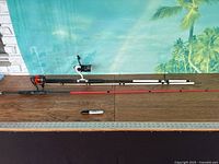 Both rods laid out with ruler for scale