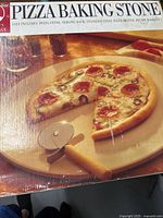 Box showing pizza baking stone set contents