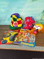 Overall lot with two hats, clown mask, program, coloring book