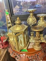 Lantern, three candle holders visible