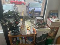 Overview showing deer figure, wreath, rope light, plate, mugs, cards, ribbon, napkins