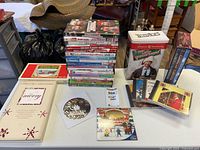Group view of DVDs, VHS tapes and CD sets on table