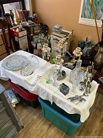 Overview of table showing crystal pieces, candelabra and stainless barware