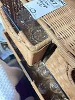 Close-up of rattan basket holding crystal tumblers and stems