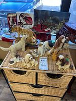 Overview of all figurines on wicker surface