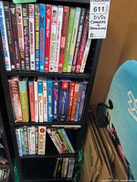 Full view of three shelves filled with comedy DVDs