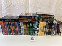 All DVD box sets arranged on table showing titles and season numbers