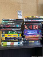 Full view of two stacks of DVD/VHS cases on shelf
