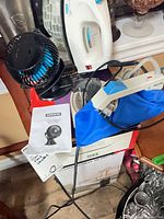 Group shot showing Black+Decker iron, Philips travel iron in pouch, Konwin fan, Honeywell heater box and manuals