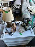 Group shot showing lamp, two lanterns, heart sculpture, ceramic figure, quartz cluster