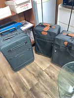 Three Denova nylon suitcases standing together