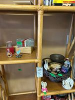 Overall shelf view showing stand, boxes, figures