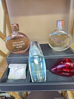 Four perfume bottles, reading crystal, black caddy