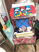 Open floral box showing ribbons, gift bags, Disney box lids