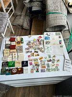 Overview of stamps and matchbooks spread on surface