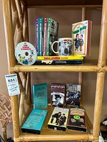 Shelf view showing all DVDs, books, mug and VHS tapes