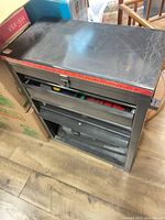 Front view of metal tool cabinet with measuring strip and drawers