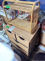Five-drawer wicker unit with small two-tier shelf placed on top