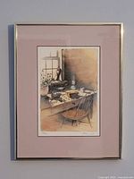Framed print showing desk still-life scene