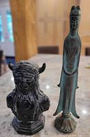 Both statues side-by-side on countertop